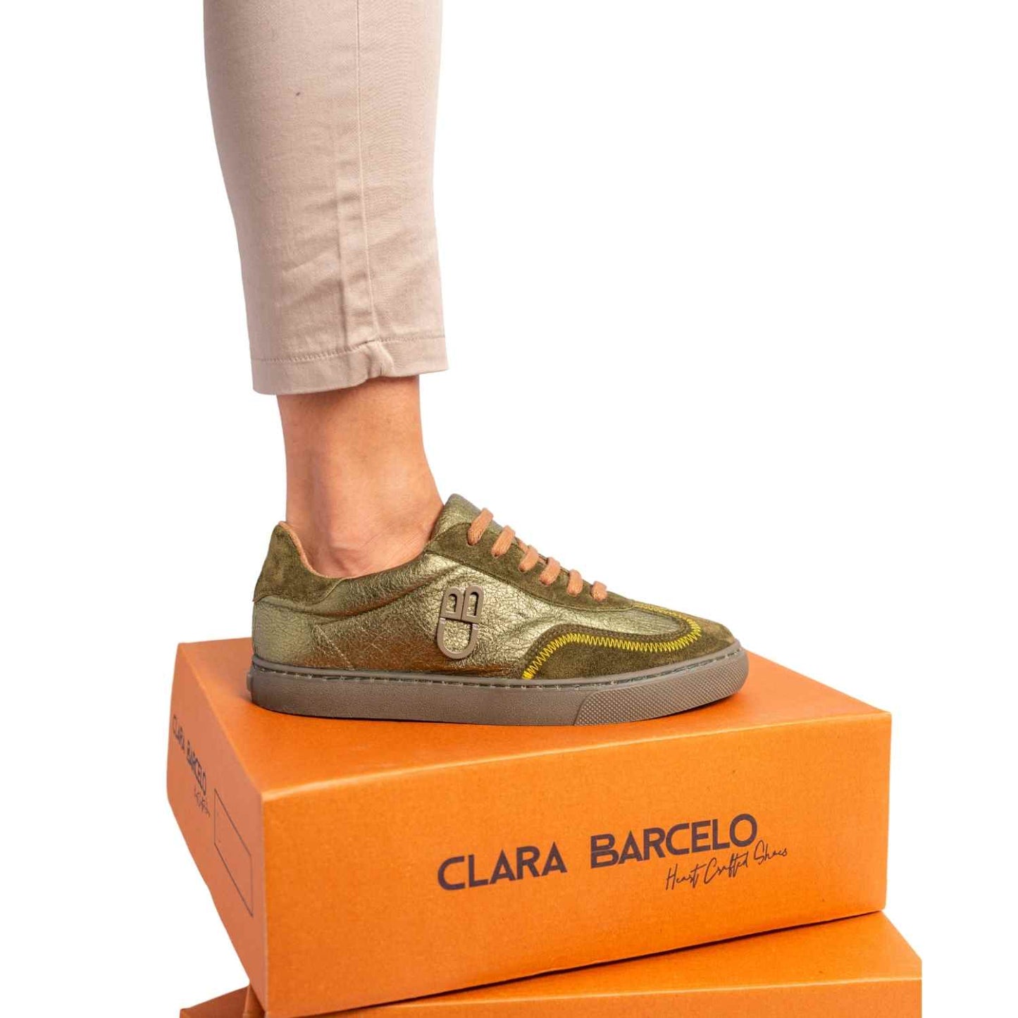Green sneaker on an orange Clara Barcelo shoe