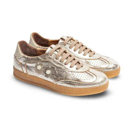 Pair of gold sneakers with brown soles 
